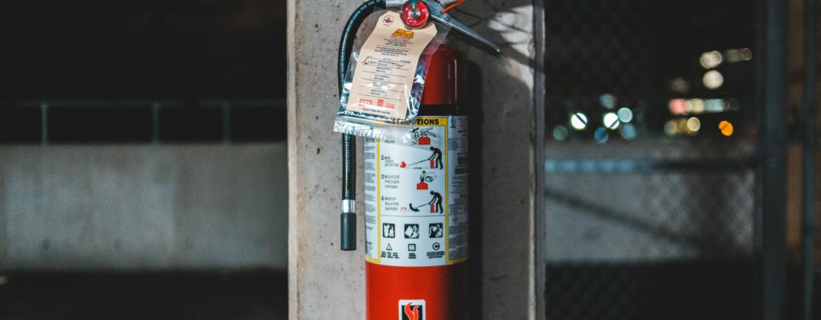 Fire extinguisher attached to stone pillar