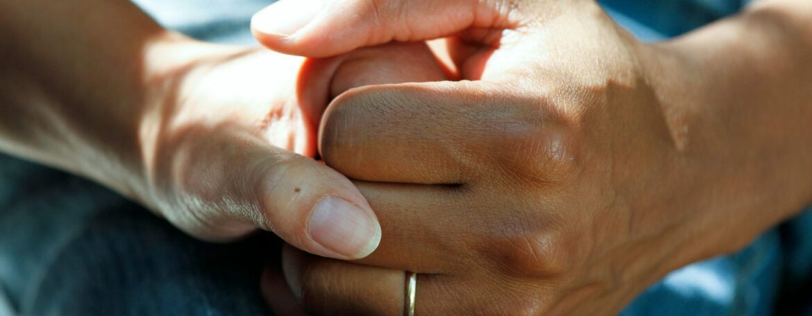 person wearing gold wedding band